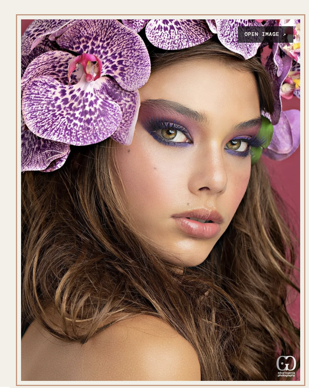 Beauty editorial close-up with purple orchids and violet eye makeup