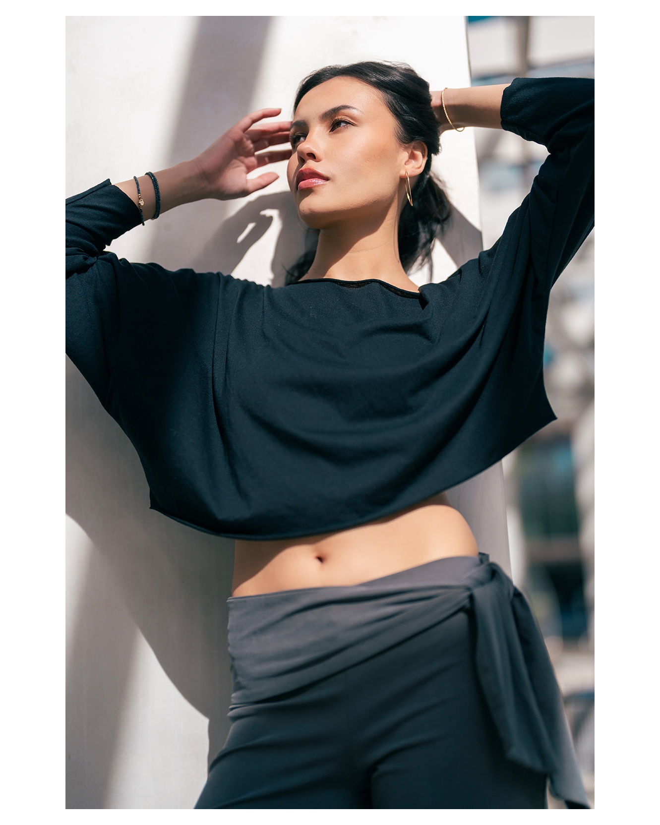 Fashion portrait in black styling and sunlight
