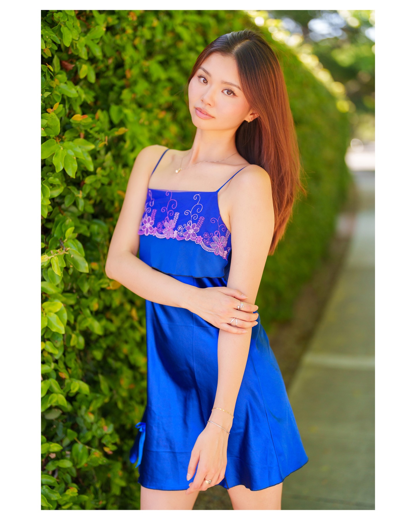 Blue fashion dress photographed in a garden setting